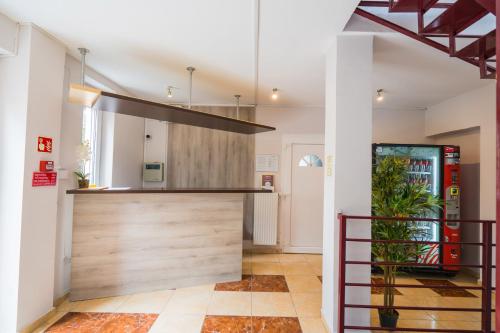 a kitchen with a bar and a soda machine at Riviéra Apartmanház in Siófok