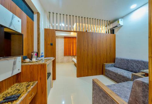 a small room with a living room with a couch at Hotel Blooming Soul in Kolhapur