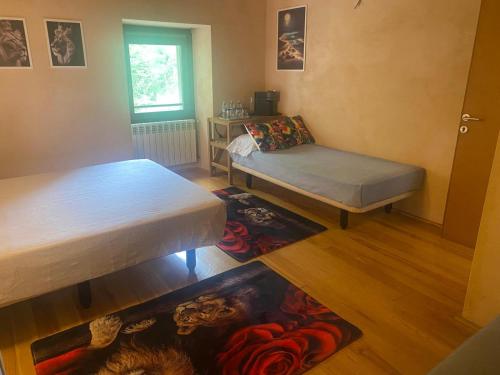 a small room with two beds and a table at Aitzkorri Zegama in Arrietas