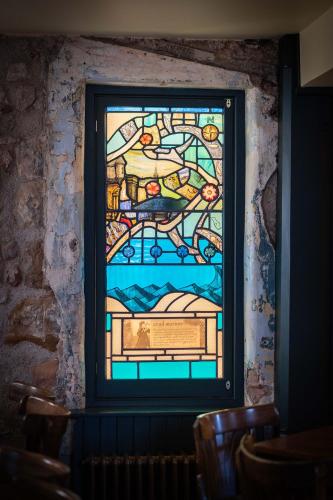 a stained glass window on the wall of a room at The Shoregate in Crail