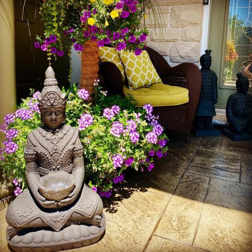 a statue in front of flowers in a room at Explorer House Bed & Breakfast in Niagara on the Lake