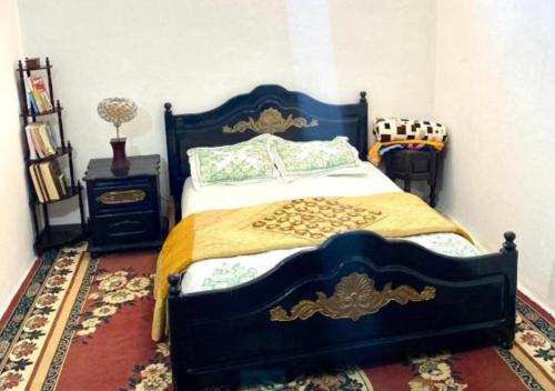 a bedroom with a blue and gold bed and a nightstand at Apartment in Safi Top Near the Sea, Morocco in Safi