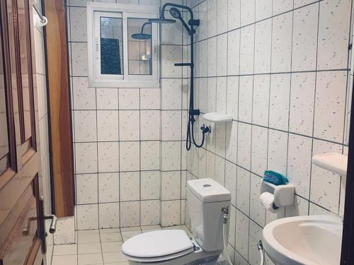 a bathroom with a toilet and a sink at Douala Cityscape Apartment, Bonamoussadi, Douala, Cameroon - ACE in Bonamoussadi