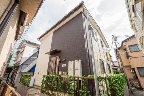 a house with a large door on the side of it at W Hostel in Tokyo
