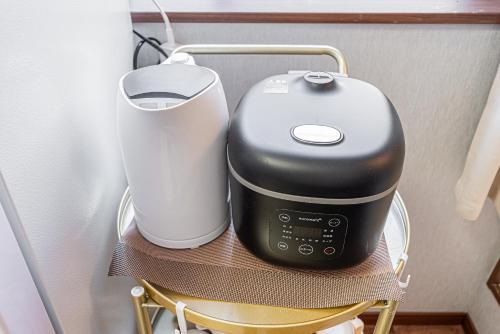 a coffee maker on a chair on a shelf at W Hostel in Tokyo