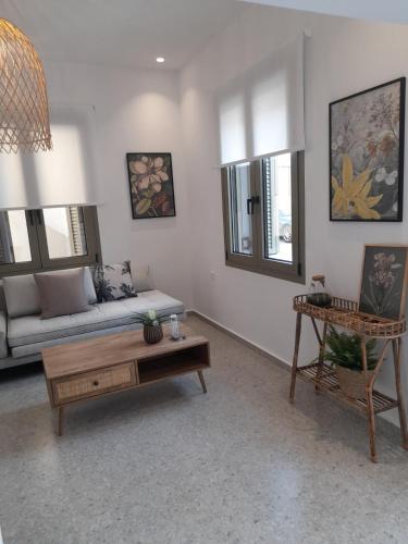 a living room with a couch and a table at Kosmos Retreat in Kos