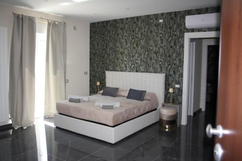 a bedroom with a large bed in a room at DIMORA GYUESY affittacamere - mini appartamenti in San Severo