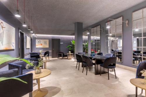 a dining room with a table and chairs at Hotel Pamplona Plaza in Pamplona
