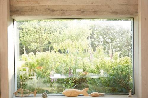 a window with a view of a garden outside at The Skyroom in Rendham