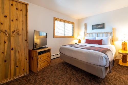a bedroom with a bed and a flat screen tv at Red Wolf Lakeside Lodge in Tahoe Vista