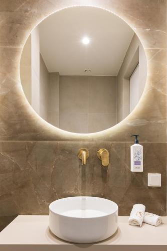 a bathroom with a sink and a mirror at Socrates Fully Equipped Apartments with Unique Design in Athens