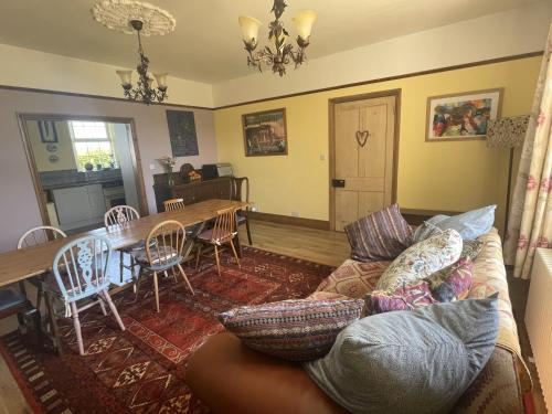 a living room with a couch and a table at Treganoon House, Lanlivery in Bodmin