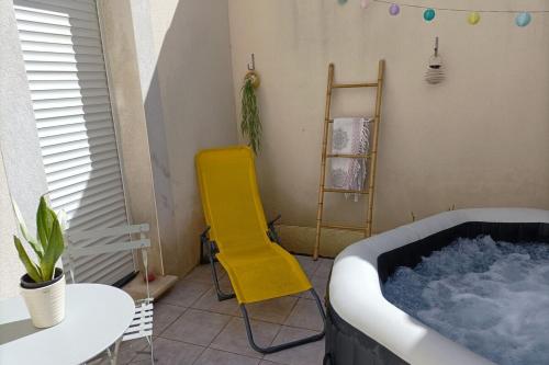 a yellow chair sitting in a tub in a room at Villa "Agathe" - 10 guests in Calvisson