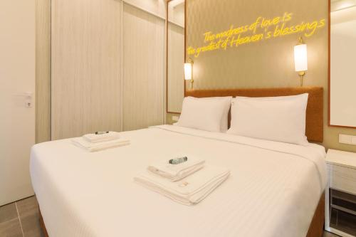 a large white bed with two towels on it at Socrates Fully Equipped Apartments with Unique Design in Athens
