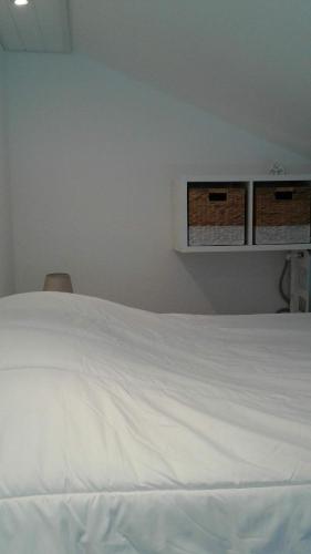 - une chambre avec un lit blanc et deux armoires dans l'établissement Studio Saint Jean De Monts, à Saint-Jean-de-Monts