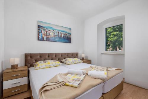 a bedroom with two beds and a window at Nada apartment in Rijeka