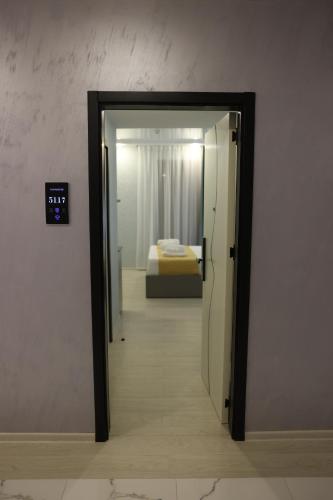 a door leading to a bedroom with a bed at OLD BaTuMi in Batumi