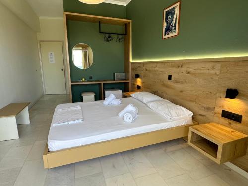 a bedroom with a bed with towels on it at Regina Hotel in Kissamos