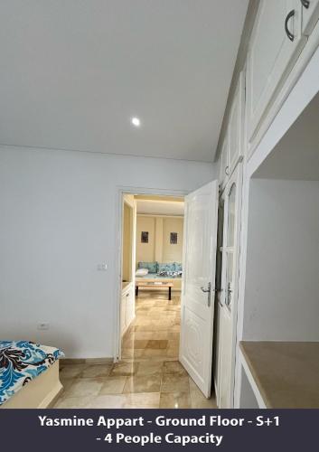 a bedroom with a bed and a doorway into a room at Tunisia Queen Apartment in Hammamet