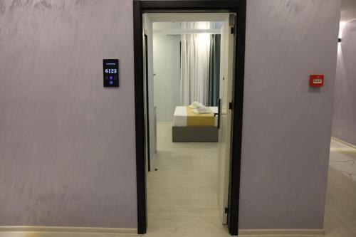 a door leading to a bedroom with a bed in a room at OLD BaTuMi in Batumi