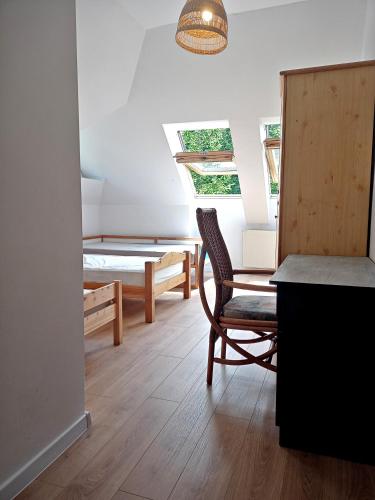 a room with a chair and a desk and a bed at Apasjonata in Świdnica
