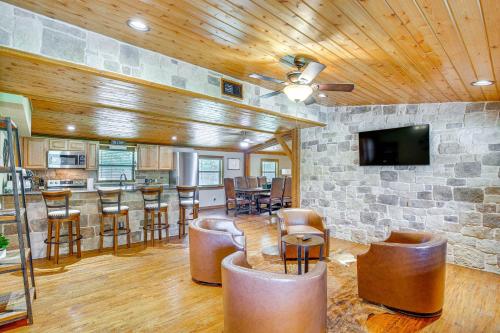 a living room with a bar and a stone wall at Deck and Fire Pit Unique Pottsboro Haven in Pottsboro