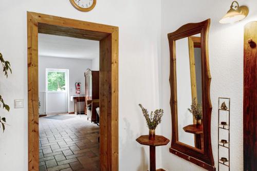 a hallway with a mirror and a table at Krüseliner Mühle - Ferienwohnungen in Krüselin