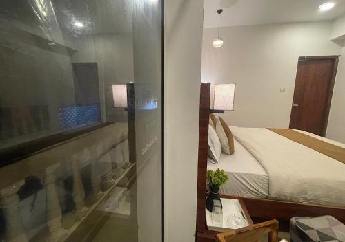 a bedroom with a bed and a glass door at Baga Vista in Baga