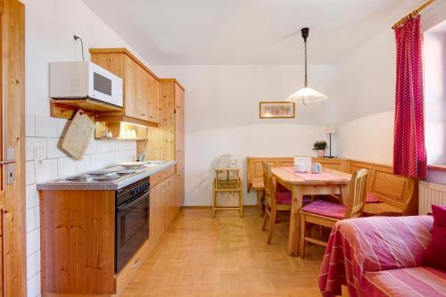 a kitchen and dining room with a table and a couch at Ferienhof Schütz in Eschlkam