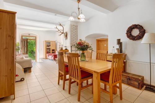 a kitchen and dining room with a wooden table and chairs at Ferienhof Schütz in Eschlkam