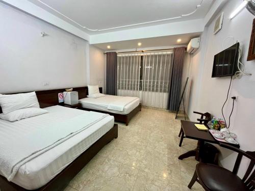 Postel nebo postele na pokoji v ubytování Khách sạn Hương Trà 1