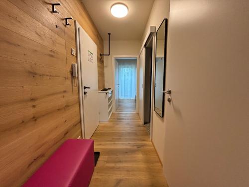 a hallway with a pink bench in a room at Livero Apartments in Sankt Pölten