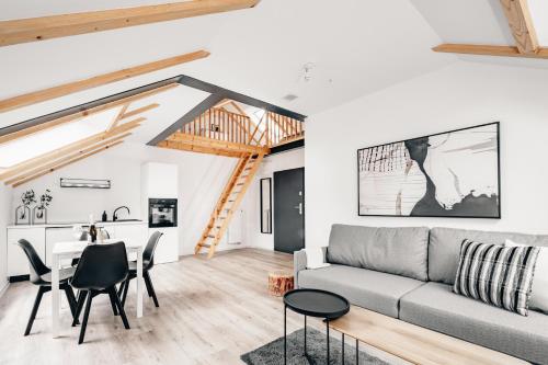 a living room with a couch and a table at Apartamenty Leszka 2, self check in 24h in Poznań