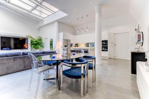 une salle à manger avec une table et des chaises en verre dans l'établissement Magnifique loft au cœur de Nice, à Nice