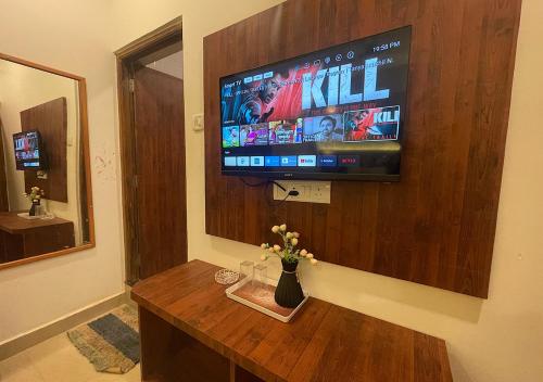 a living room with a flat screen tv on a wall at Baga Vista in Baga