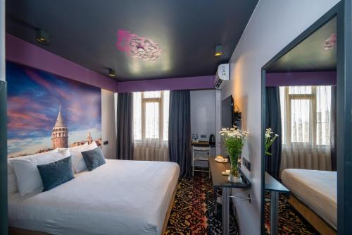 a hotel room with two beds and a purple ceiling at Tulip City Hotel & Spa - Istanbul Taksim Pera City Center in Istanbul
