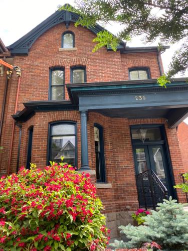 a brick house with flowers in front of it at Downtown Luxury Victorian Retreat in Toronto