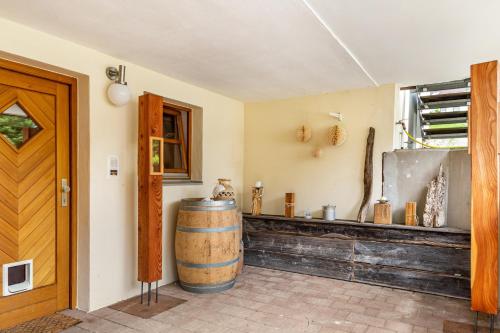 a room with a wooden door and a barrel at Ferienwohnung Schatzlmayr in Vilshofen an der Donau