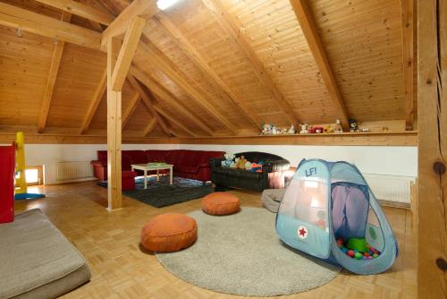 a living room with a childs play room with a couch at Ferienhof Schütz in Eschlkam