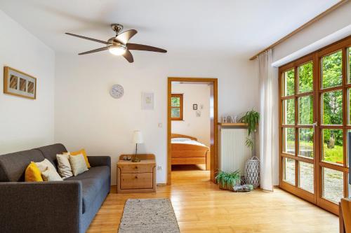 a living room with a couch and a ceiling fan at Ferienwohnung Schatzlmayr in Vilshofen an der Donau
