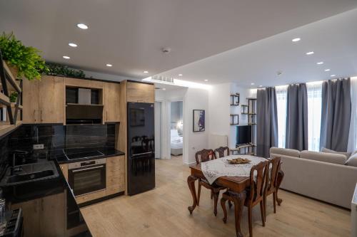 a kitchen and living room with a table and chairs at Art Hotel in Sarandë
