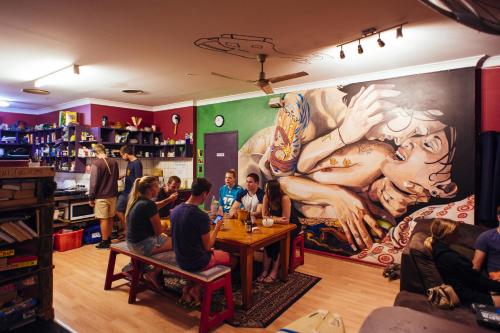 a group of people sitting at a table in a restaurant at Beachside Backpackers in Port Macquarie