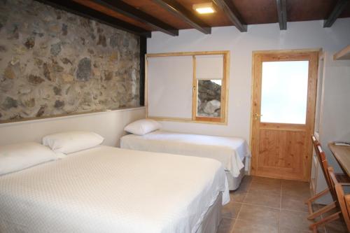 Ένα ή περισσότερα κρεβάτια σε δωμάτιο στο Posadas Aurelio