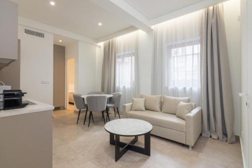 a living room with a couch and a table at Socrates Fully Equipped Apartments with Unique Design in Athens