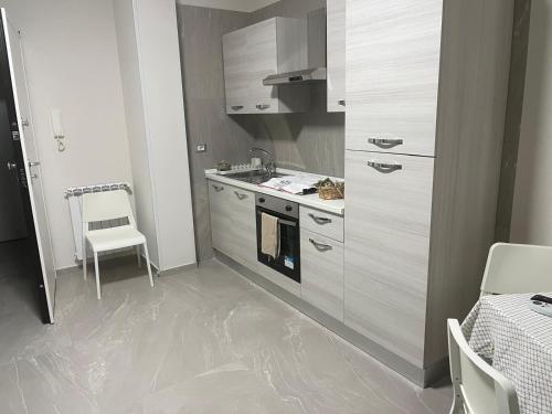 a kitchen with a stove and a stove top oven at Alysia House in Naples