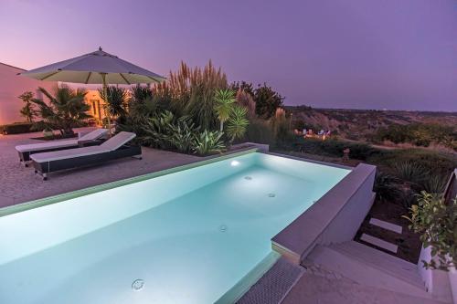 a swimming pool in the backyard of a house at Torre Fiore Hotel Masseria in Pisticci