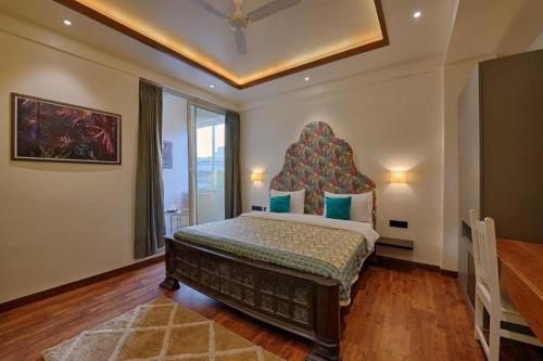 a bedroom with a large bed in a room at Gulmohar Mansion - A Boutique Stay in Jaipur