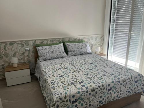 a bedroom with a bed with a floral comforter at Alysia House in Naples