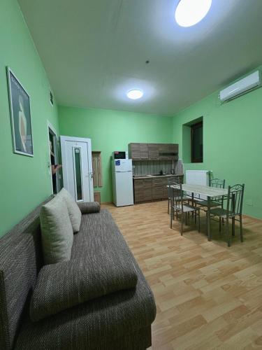a living room with a couch and a table at Heviz Gracia Apartment in Hévíz