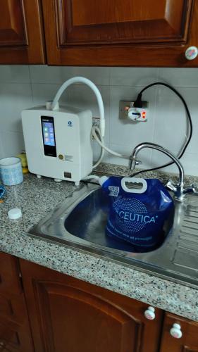 a kitchen sink with a toaster and a blue bag at I Sollazzi in Palermo